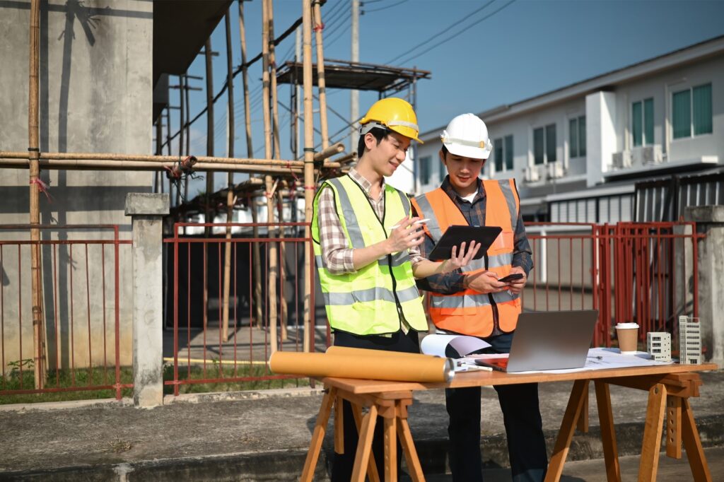 A homeowner and a contractor evaluating costs to determine if is it cheaper to buy or hire scaffolding for renovations on a residential site.